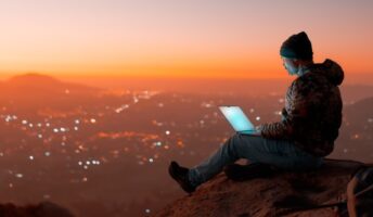 Digital nomad sitting on a rock