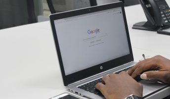 man using google chrome on a laptop
